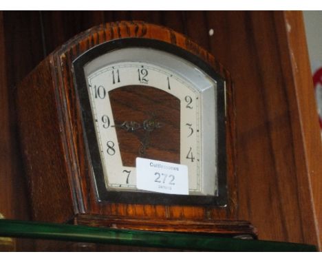 AN ART DECO OAK DOMED MANTEL CLOCK 