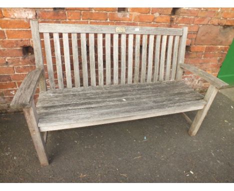 A WOODEN GARDEN BENCH