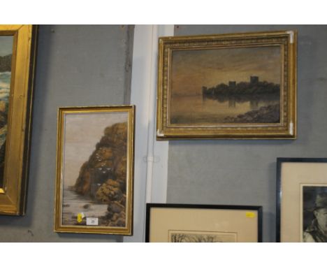 A GILT FRAMED VINTAGE OIL ON CANVAS SIGNED J FERRY DEPICTING A DISTANT CASTLE TOGETHER WITH A FRAMED AND GLAZED ROCKY COASTAL