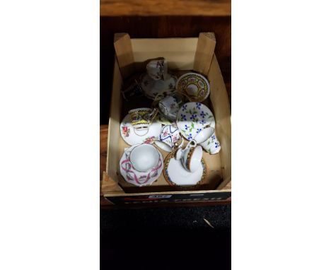 COLLECTION OF MINIATURE CUPS AND SAUCERS