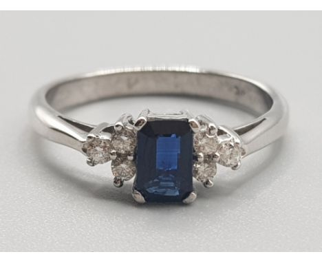 Ladies 9ct white gold sapphire &amp; diamond ring, comprising of a blue sapphire set in the centre with 3 round brilliant cut