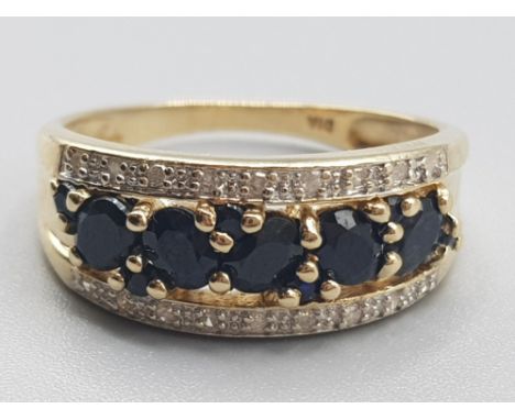 Ladies 9ct yellow gold ornate sapphire &amp; diamond ring, comprising of 5 oval shaped sapphires set with small diamonds eith