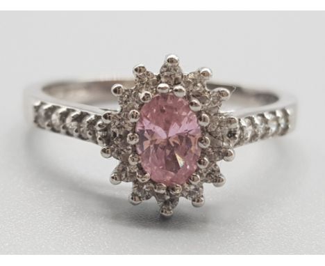 Ladies 9ct white gold pink &amp; white stone cluster ring, comprising of a oval pink stone in the centre surrounded by white 