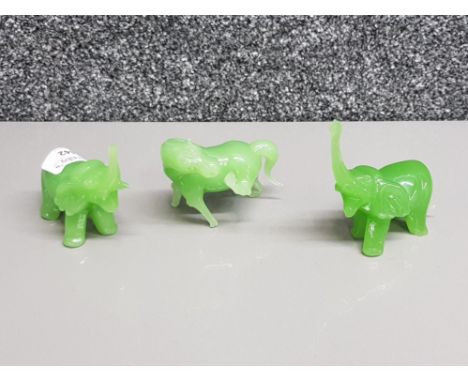 Three jade carvings of a horse and two elephants.