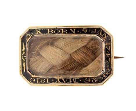 An early 19th century gold and enamel mourning brooch, set with plaits of hair, the black enamel border inscribed 'A.K. BORN 