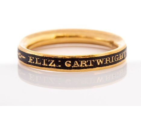 An 18th century gold and black enamel mourning ring, the band applied with black enamel inscribed 'ELIZ CARTWRIGHT DIED 10 NO