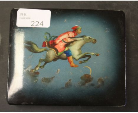 A Russian painted trinket box, the lid decorated with mounted Cossack(?) horseman riding through the sky, signed in Cyrillic 