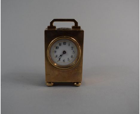 A Miniature 9ct Gold Cased Carriage Clock with Silver Monogrammed and Laurel Leaf to Top. Four Bun Feet, 5cm High 