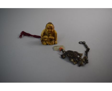 A Carved Oriental Netsuke in the Form of Seated Scribe with Book Together with Jade and Coral Mounted White Metal Fish Pendan