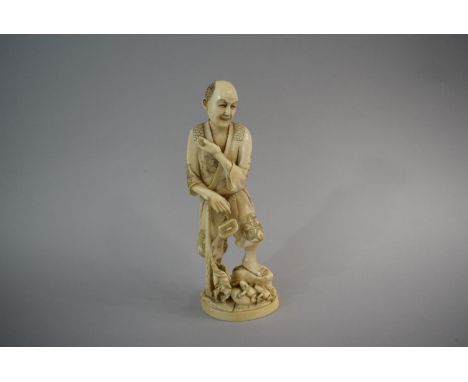 A Late 19th/Early 20th Century Oriental Carved Ivory Okimono In the form of Elder with Stick, Pipe and Purse and Two Frogs at