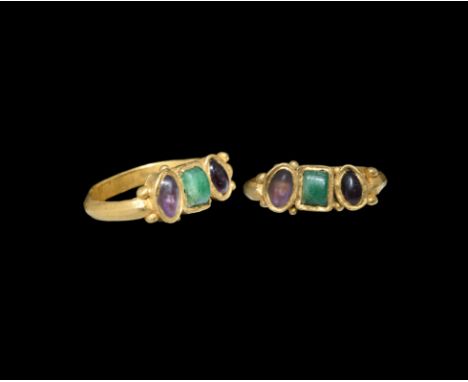 2nd century AD. A gold finger ring with D-section hoop, bezel of two ellipsoid cells with amethyst cabochons and a rectangula