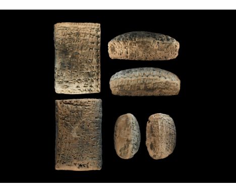 Dated 1886 BC. A ceramic pillow-shaped tablet with Akkadian cuneiform text to both broad faces, one long and one short edge, 