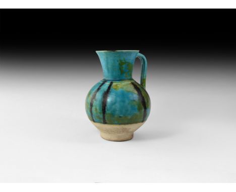 13th-14th century AD. A ceramic part-glazed jug with trumpet-shaped neck, ribbed shoulder and bulbous body, strap handle with