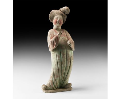 Tang Dynasty, 618-906 AD. A finely modelled hollow ceramic figurine of a courtly lady with dressed hair and draped robe, arms