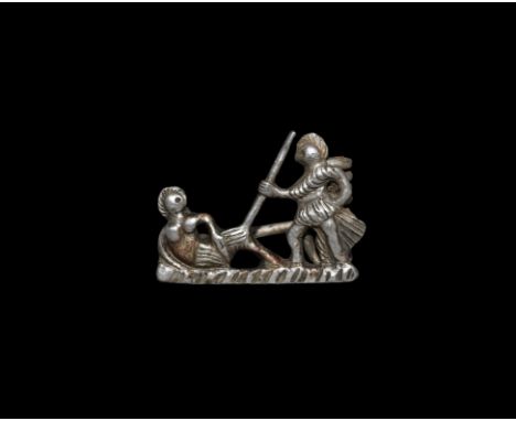 2nd century AD. A silver plate brooch depicting a triumphant gladiator attacking a fallen opponent on a hatched base line, sp