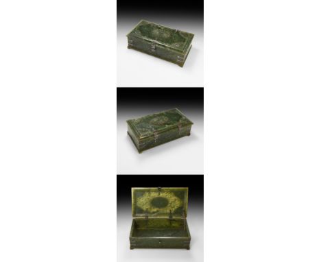 19th century AD. A carved nephrite jade rectangular lidded box with silver fittings; the body with stub feet and silver reinf