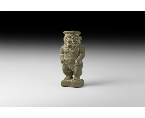 Saite Period, 26th Dynasty, 664-525 BC. A substantial carved rhyolite kohl jar formed as a figure of Bes standing nude with t