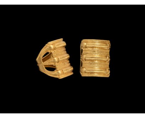 2nd century AD. A gold finger ring with flared hoop, three ribbed bands to the bezel with openwork shoulders, each band with 