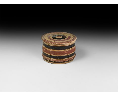 5th century BC. A ceramic lidded pyxis with circumferential rings in red and black to the sidewall, concentric rings to the l