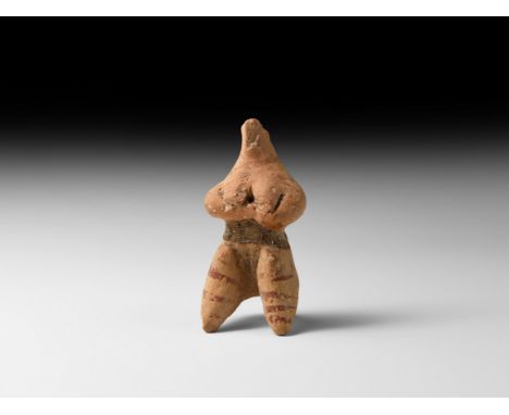 5th-4th millennium BC. A ceramic figurine depicting a seated female with the hands supporting large breasts, small head with 