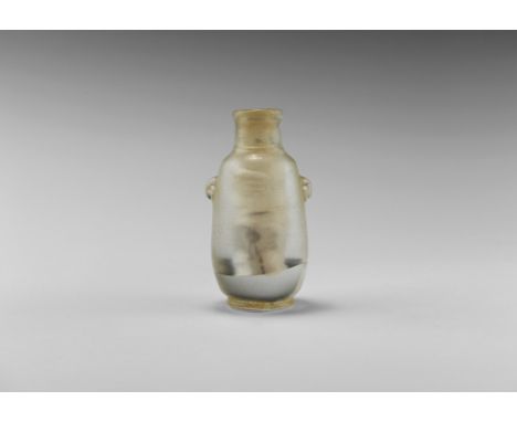 1st millennium BC or later. A carved rock crystal amphoriskos with two lateral loop handles, irregularly drilled interior. [A