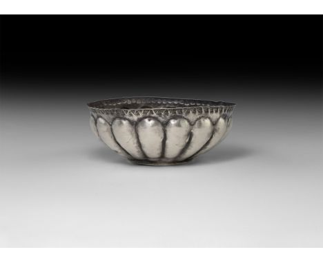10th-12th century AD. A 6th-4th century BC sheet silver fluted bowl, later embellished by with a band of stamped Viking decor