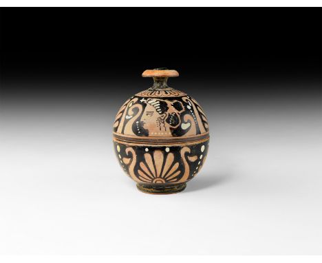 South Italian, Apulia, 320-300 BC. A ceramic pyxis of spherical form with small stepped foot and chamfered button handle; the