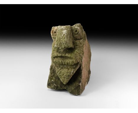 12th-14th century AD. A substantial sandstone block from an architectural feature with naive carved human face, weathered on 