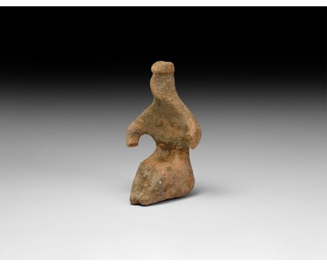 6th-5th millennium BC. A ceramic figurine of a seated female with applied hair, pinched face and arms, legs with knees raised