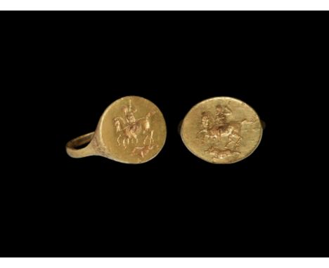 1st century BC. A gold finger ring with ellipsoid bezel, intaglio of a mounted huntsman with a spear preparing to kill a runn