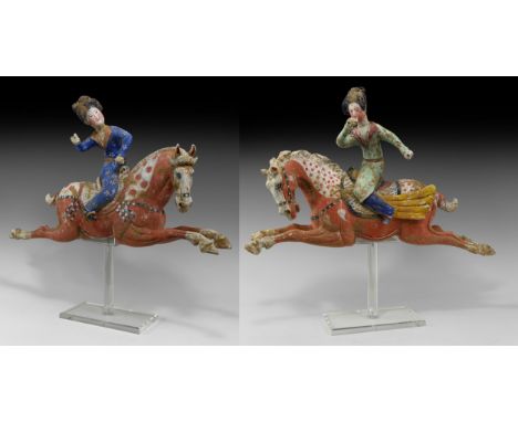Tang Dynasty, 618-906 AD. A dynamic pair of ceramic polo-player figures each a galloping horse with legs extended and mane fl