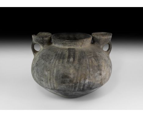 1st millennium BC. A large ceramic vessel with squat bulbous body, the upper half with raised ribs flanking bands of zig-zag 