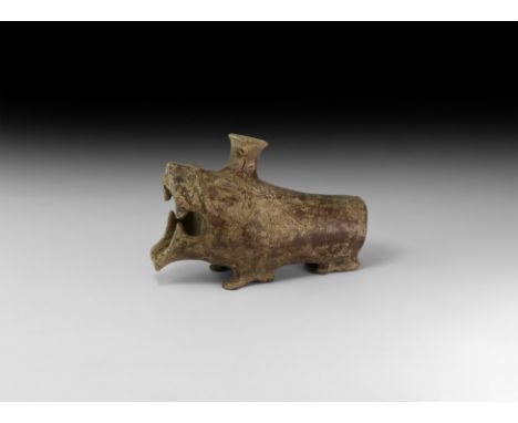 1st millennium BC. A ceramic rhyton formed as a stylised lion with tubular body, applied legs underneath, applied ears and cu