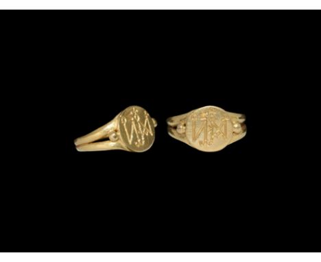 6th-7th century AD. A flat-section gold hoop with bifid expanding shoulders, applied bezel engraved with a complex monogram, 