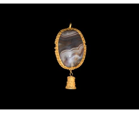 2nd-3rd century AD. A pendant comprising a plano-convex banded agate panel in a gold frame with beaded rim and panels of gran