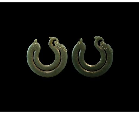 17th century AD or later. A matched pair of carved jade pendants, each a penannular serpent-dragon in crescent outline with i