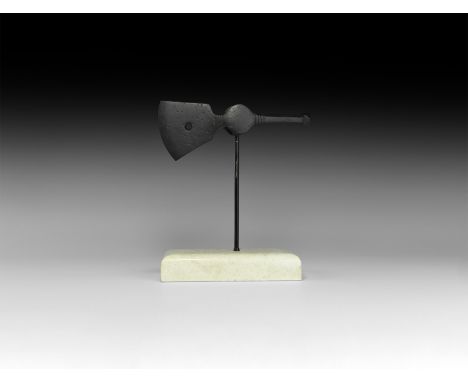 11th-12th century AD. An iron axehead with flared blade, pierced through the middle, rectangular socket with circular plaques