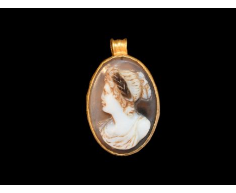 1st-2nd century AD. A onyx cameo portrait bust of a young female wearing a chiton, her hair dressed in a chignon, laurel-leaf
