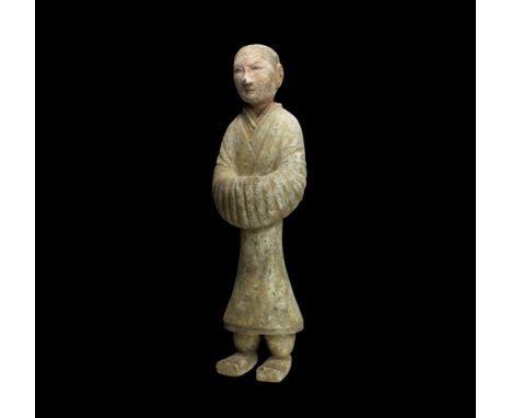 Han Dynasty, 206 BC-220 AD. A ceramic figure of a court attendant in calf-length robe and square-toed shoes, arms in billowin