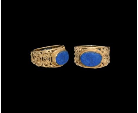 6th-7th century AD. An ellipsoid blue glass cloison set in a cell with filigree collar, ring formed as two tapering bands wit