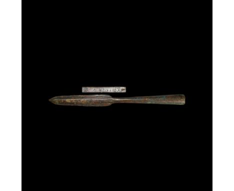 13th-6th century BC. A bronze spearhead with leaf-shaped blade, long tubular neck and split socket; midrib with short incised