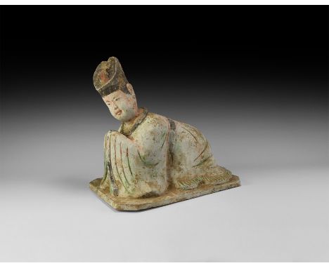 Tang Dynasty, 618-906 AD. A ceramic figure of a court official in headdress and robes in the prostrate 'kow tow' posture of r
