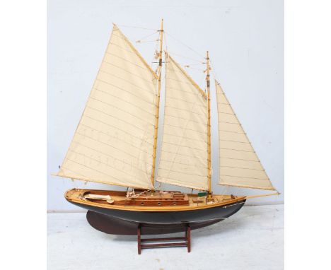 A large hand made model sailing yacht with full sails and rigging, on a display stand. 113 cm high.