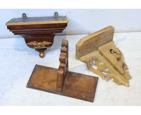A 19th century mahogany clock bracket, together with two others. (3)