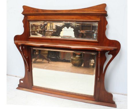 An Edwardian mahogany over mantel mirror, with a single shelf and two mirrored panels. 122 cm wide.