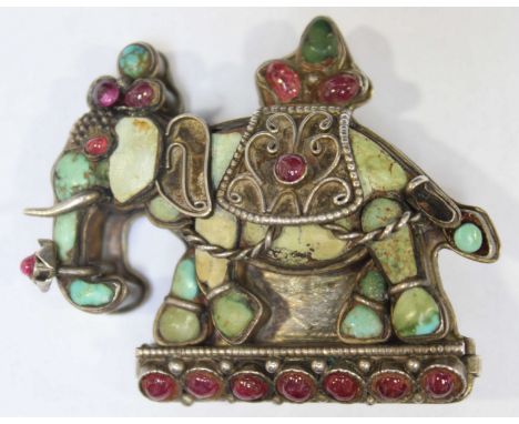 An Indian turquoise and ruby elephant brooch, set in white metal, probably silver.