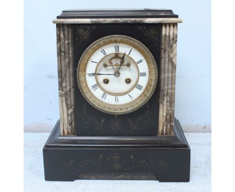 A Victorian black slate mantel clock, with white enamel dial and brass bezel. 33 cm high.