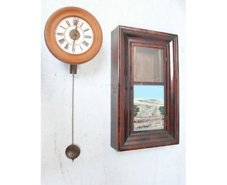 A 20th century circular wall clock, with pendulum and white enamel dial. 26 cm diameter, together with an American Ansonia cl
