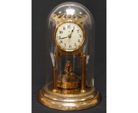 A 20th century brass anniversary clock, with oscillating brass disc pendulum, Arabic numerals to the white enamel dial, glass