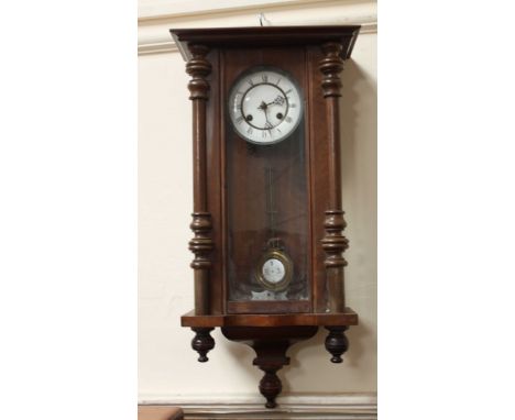 A Victorian style Vienna wall clock with white enamel dial.